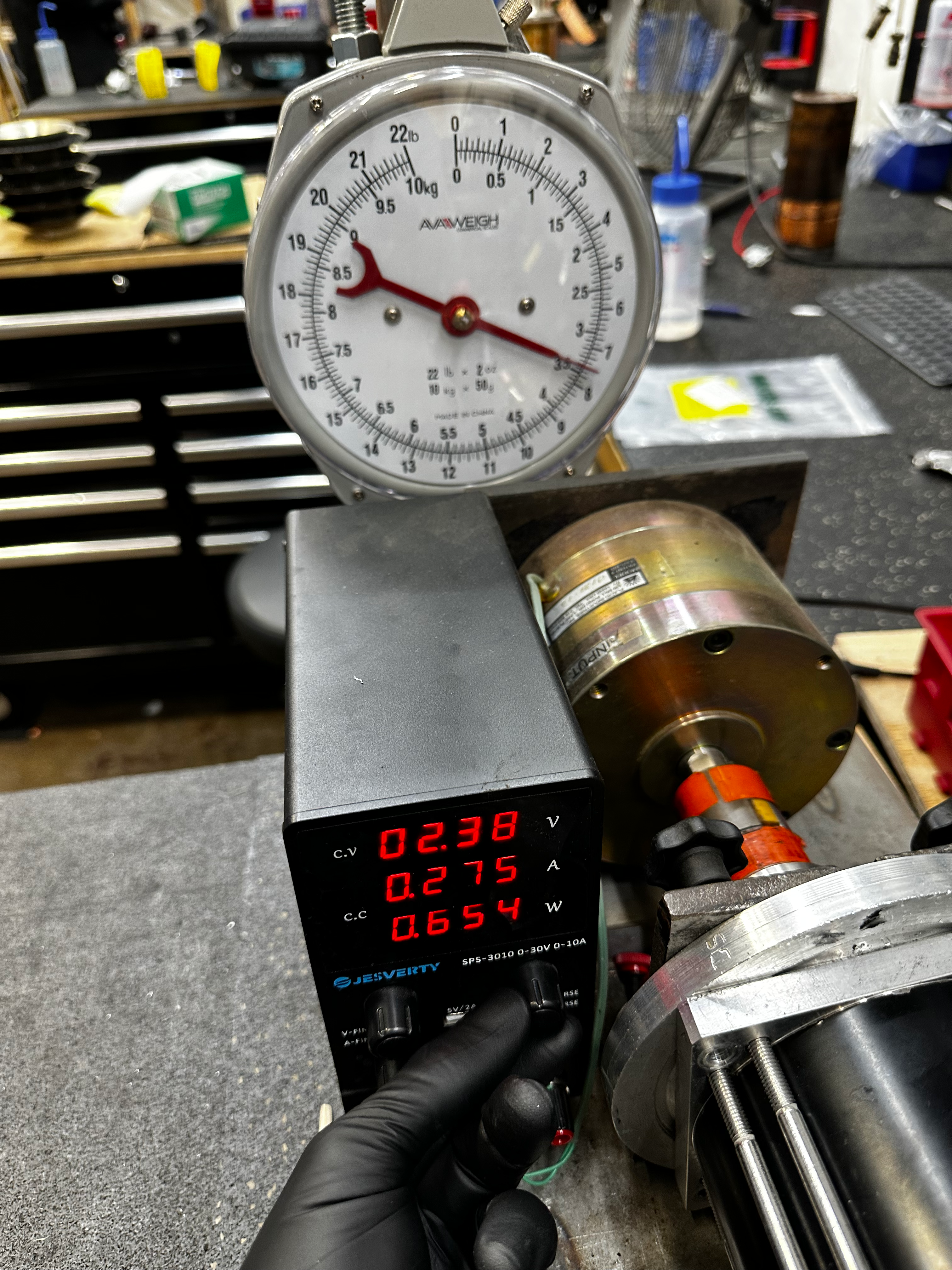 The needle rising on the scale and the voltage increasing on the power supply display.