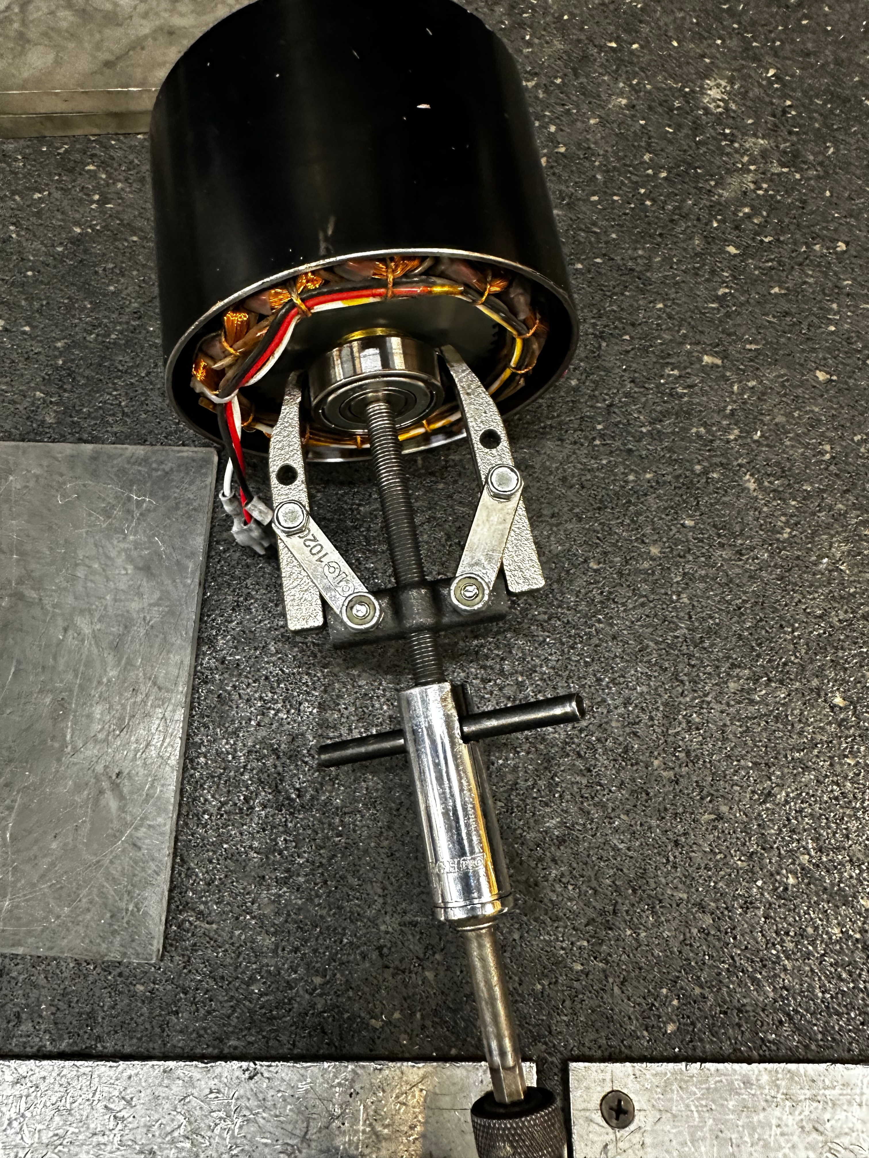 2 jaw pullers with impact gun on back plate bearing.