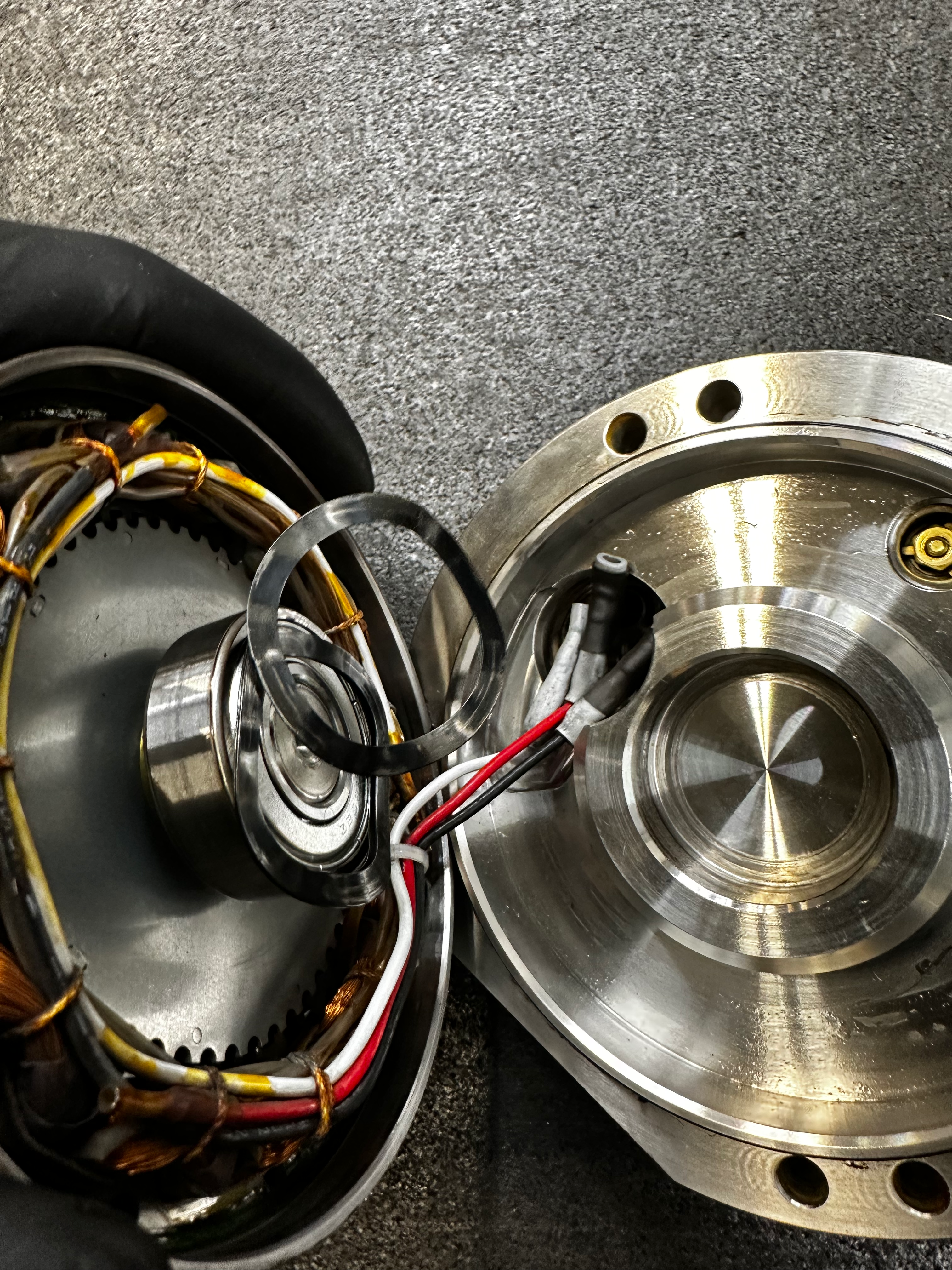 Rotate the back plate to expose the electrical connections.