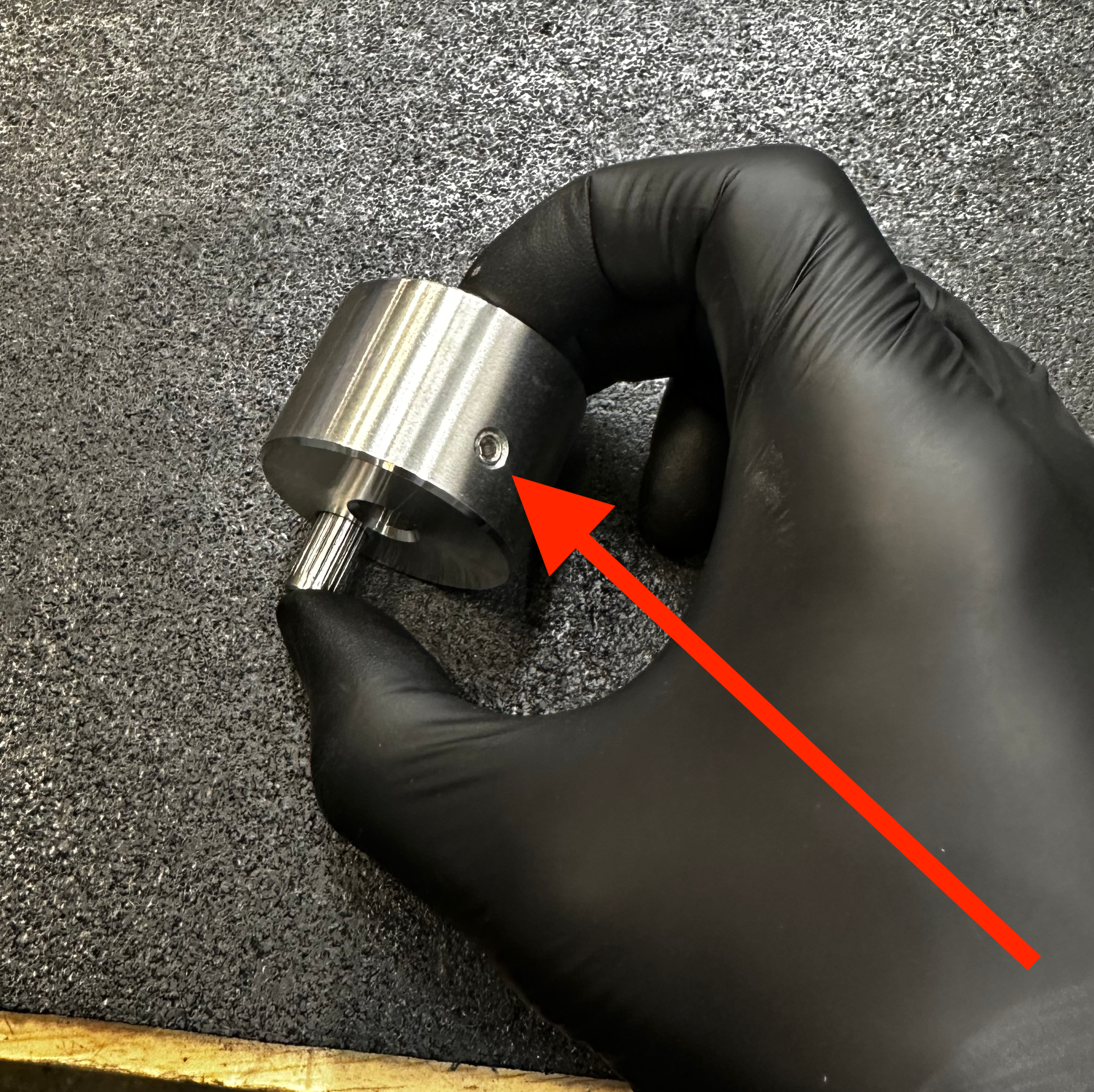 The set screw on the back side of the crank.