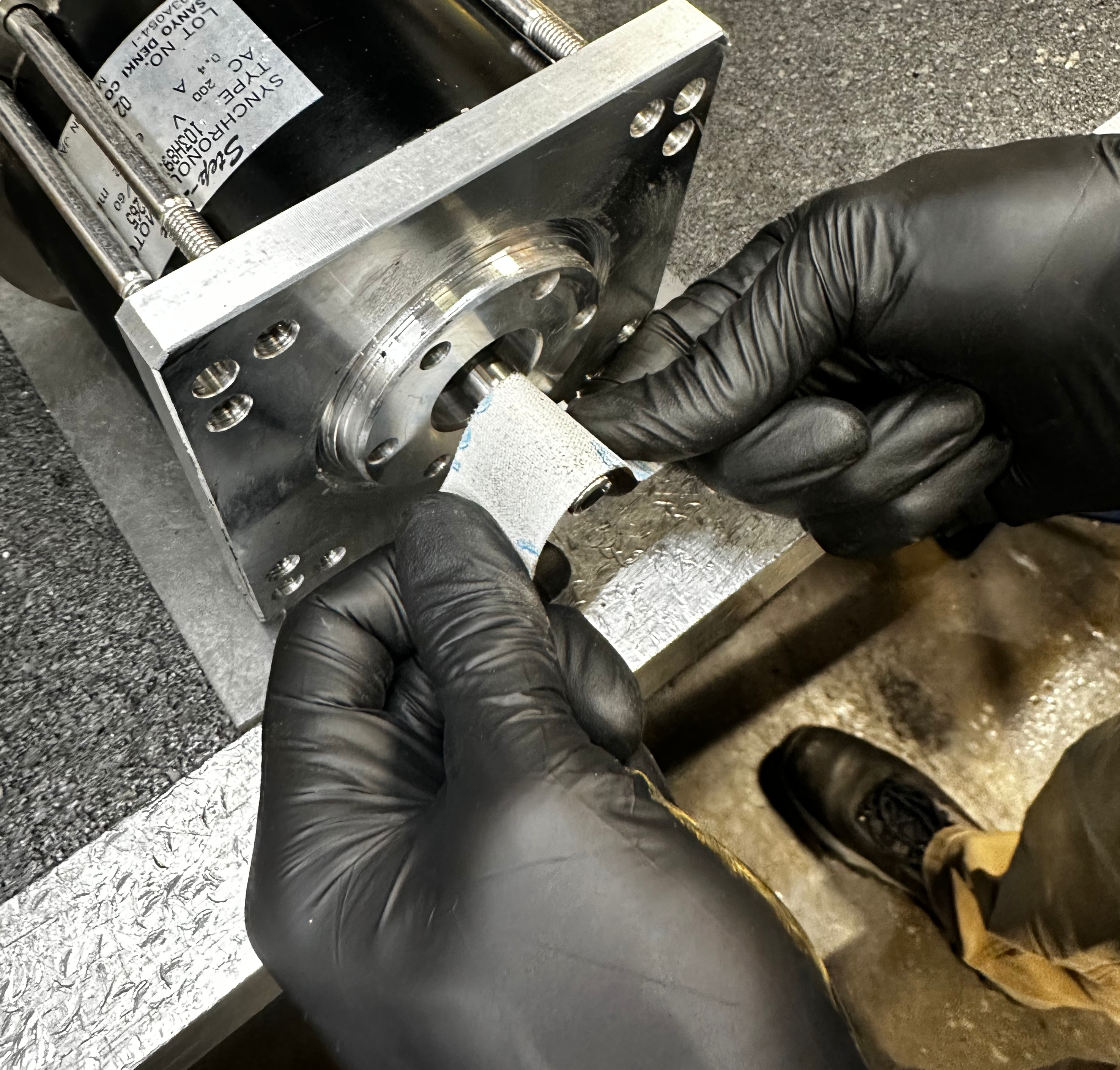 Buffing the rotor shaft with emory cloth.